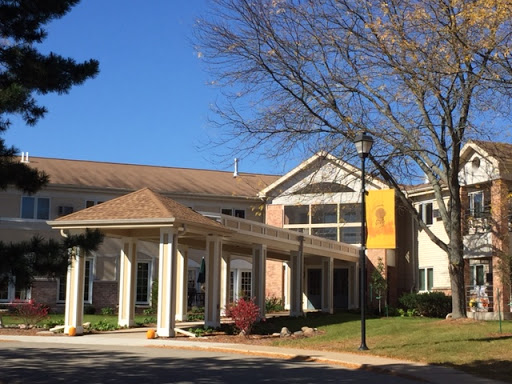 A welcoming entrance to a residential building under a clear blue sky.
