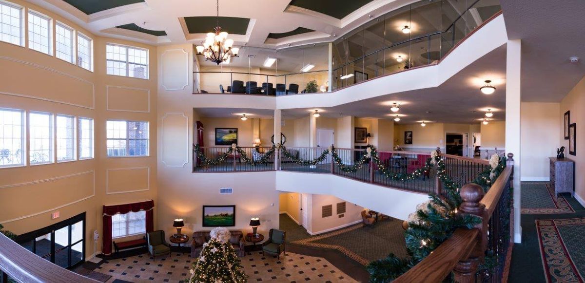 A spacious and modern lobby area with multi-level viewing, featuring elegant lighting and furnishings.