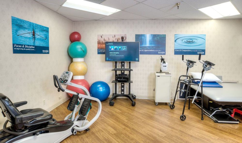 A physical therapy room equipped with exercise equipment and fitness balls.