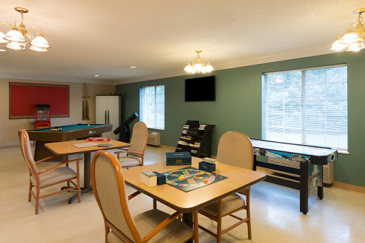 A cozy recreational room featuring tables and chairs, ideal for gatherings and activities.