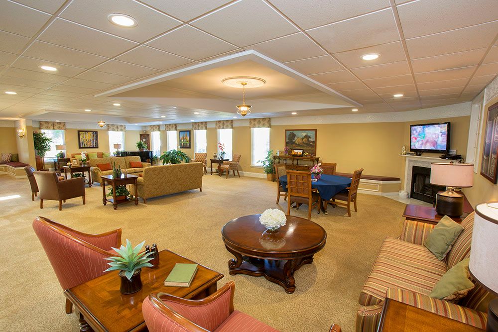 A spacious and well-furnished living room with various seating arrangements and decor.