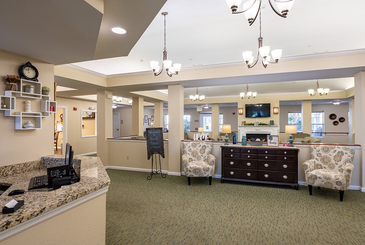 A welcoming lobby area with comfortable seating, chandeliers, and a reception desk.