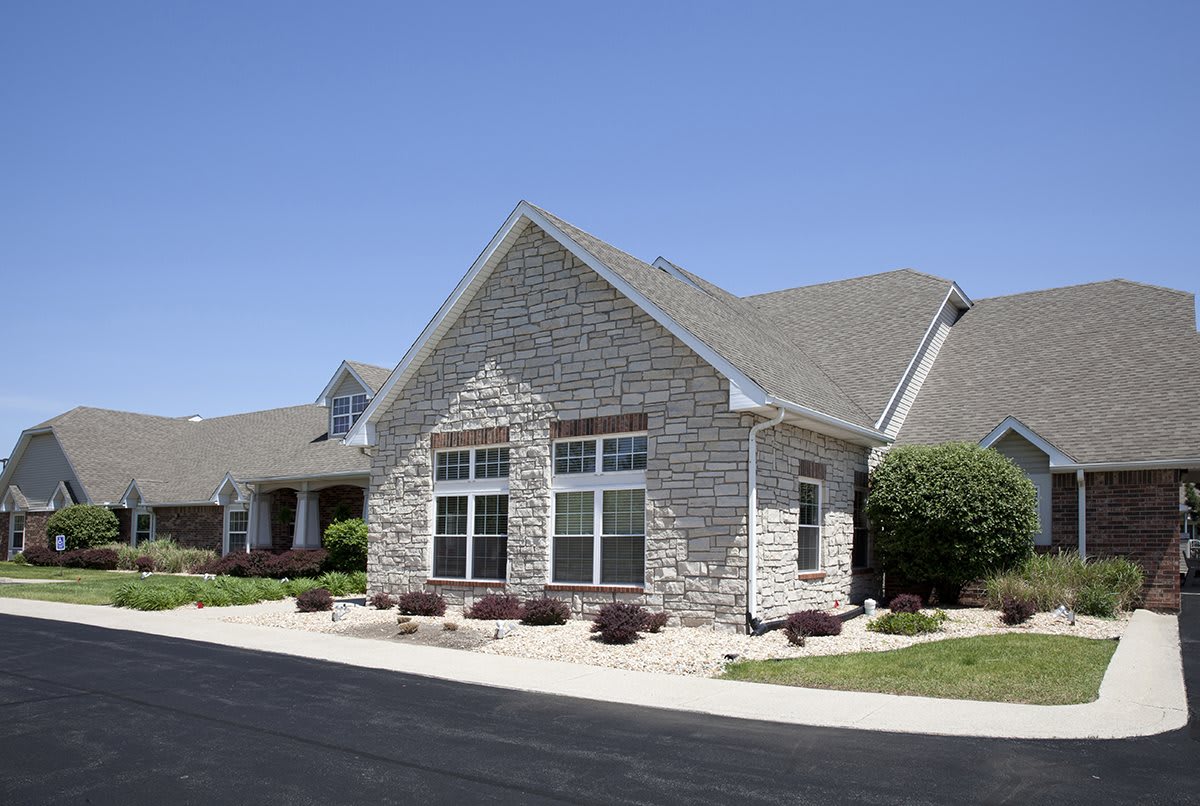 A suburban residential house with stone facade and a well-maintained exterior.