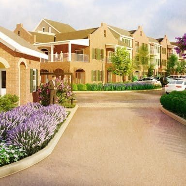 A beautifully landscaped residential area with brick buildings and a flower-lined pathway.