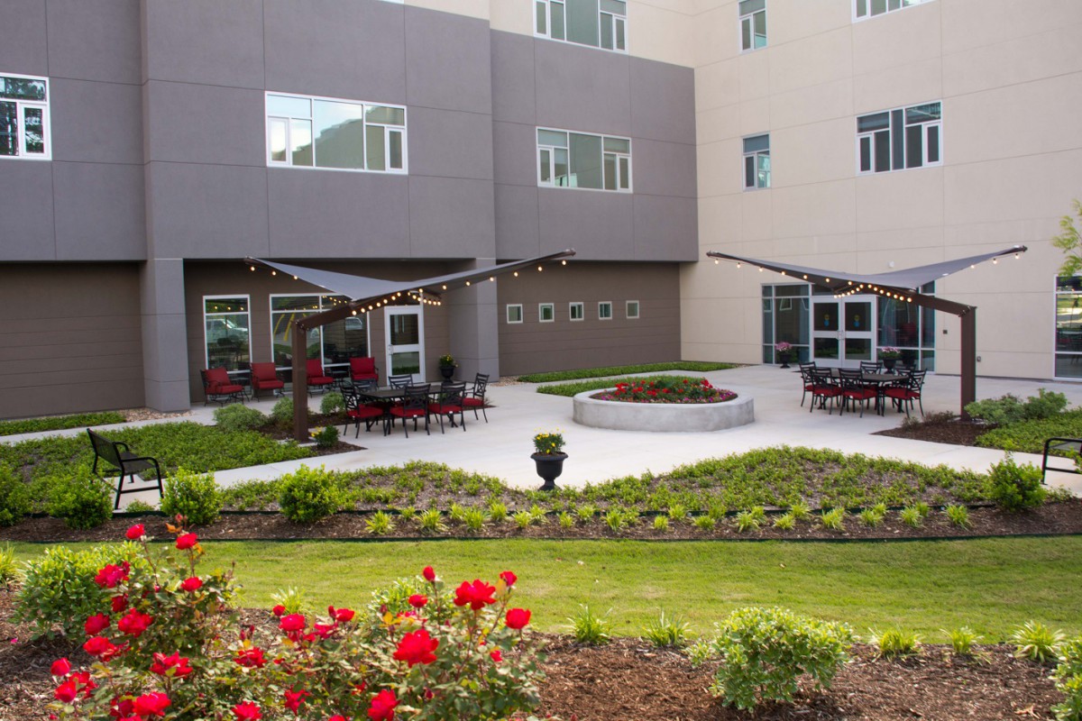 A modern courtyard with landscaped gardens and outdoor seating areas.