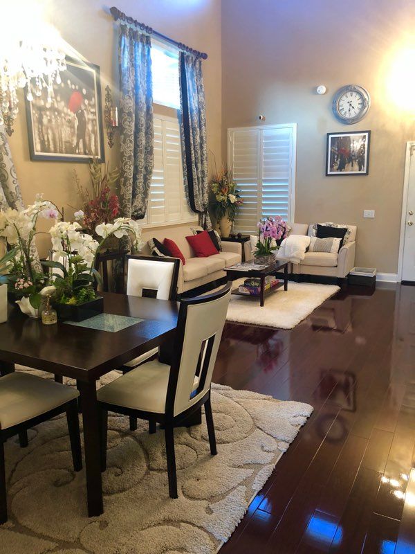 A stylish living and dining area with elegant decor and warm lighting.