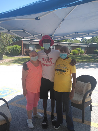 Community members gather for a supportive event while practicing safety precautions.