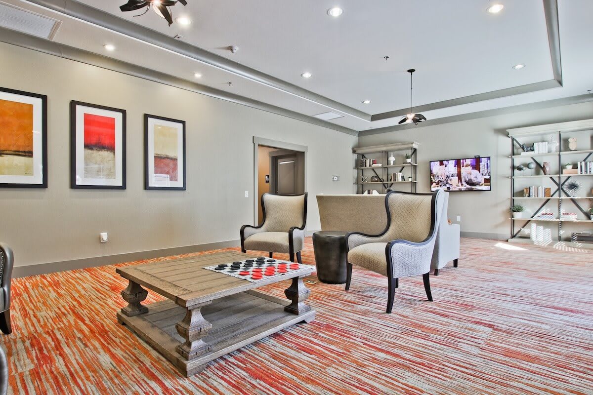 A modern lobby with stylish furniture and artwork on the walls.