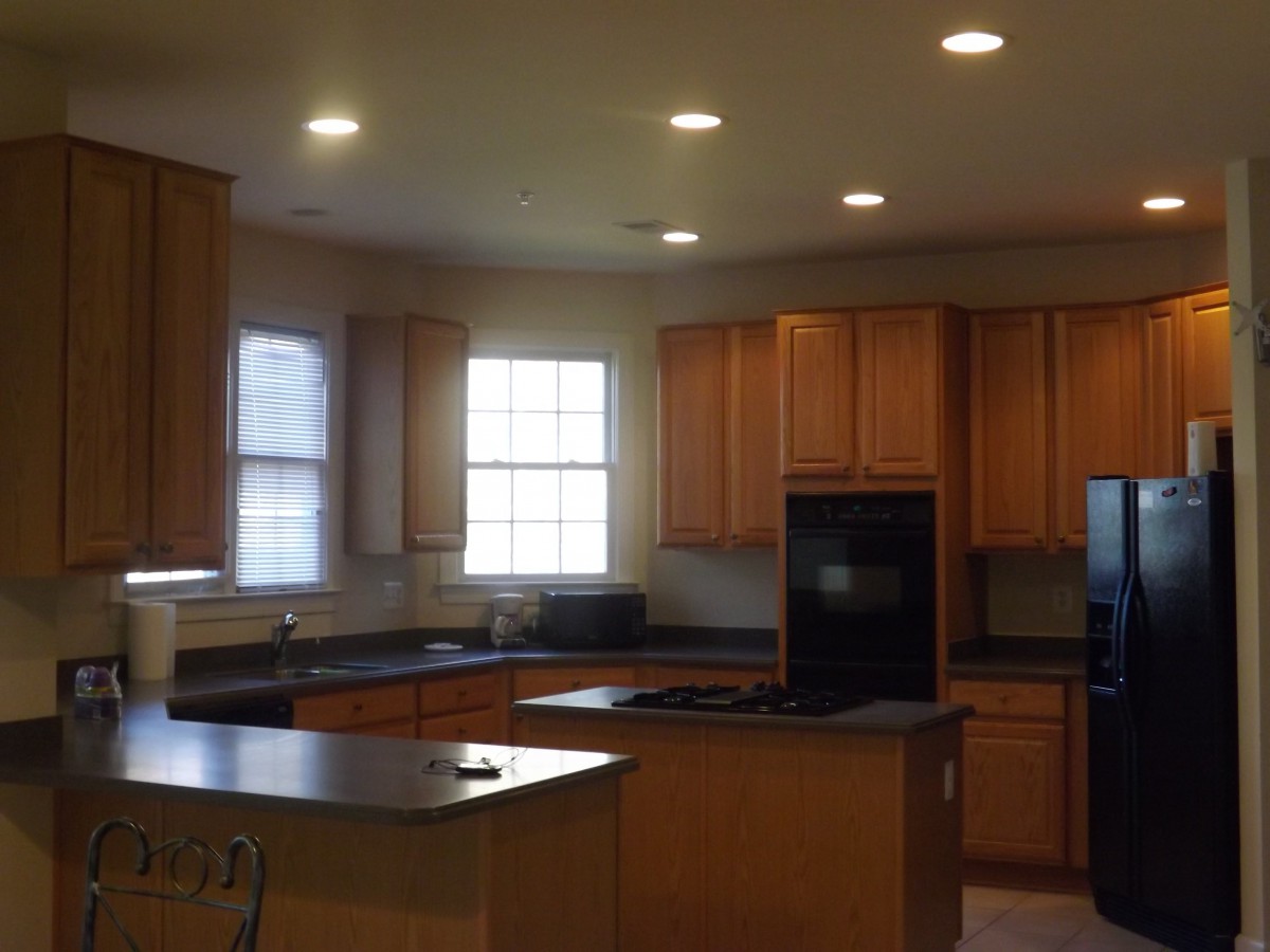 A spacious kitchen with wooden cabinets and a central island.