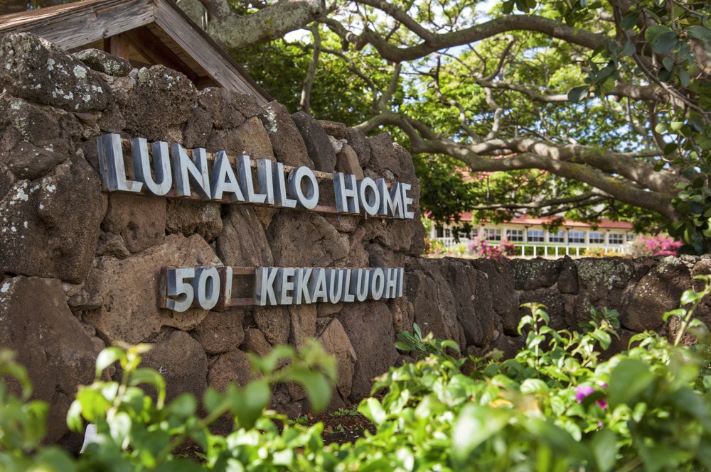 Entrance sign of Lunalilo Home surrounded by lush greenery.