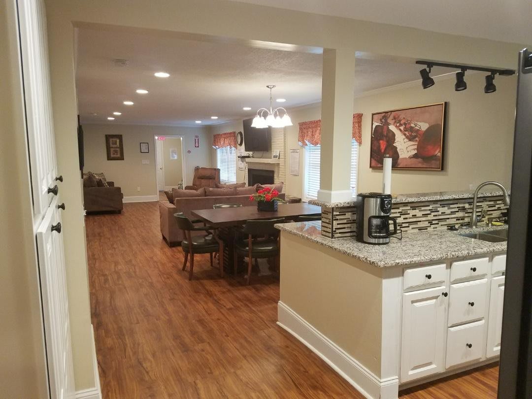 A modern open-concept kitchen and dining area with hardwood floors.