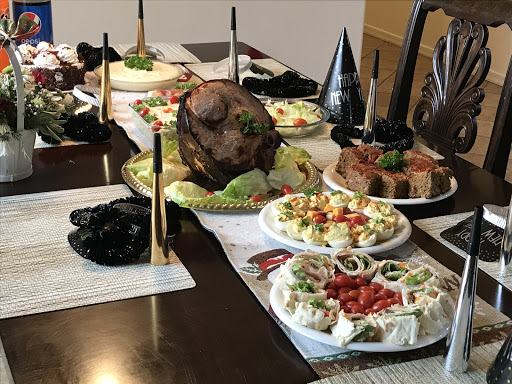A beautifully set dining table featuring a variety of dishes including a main course and colorful appetizers.