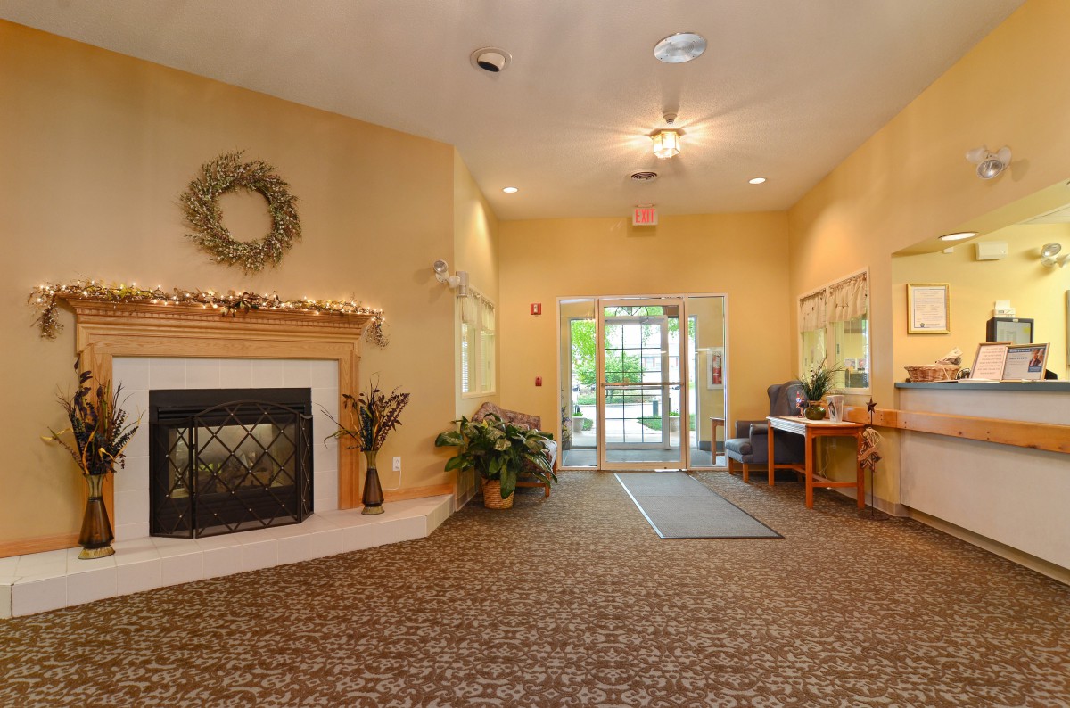 A cozy lobby with a fireplace and welcoming entrance.