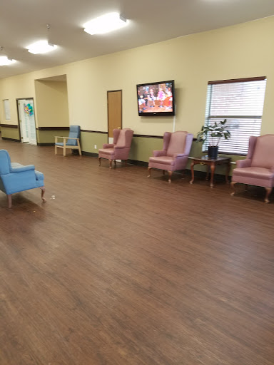A spacious lobby featuring comfortable seating options and a television.
