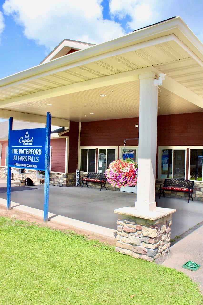 Entrance to a vacation rental building with a welcoming sign.