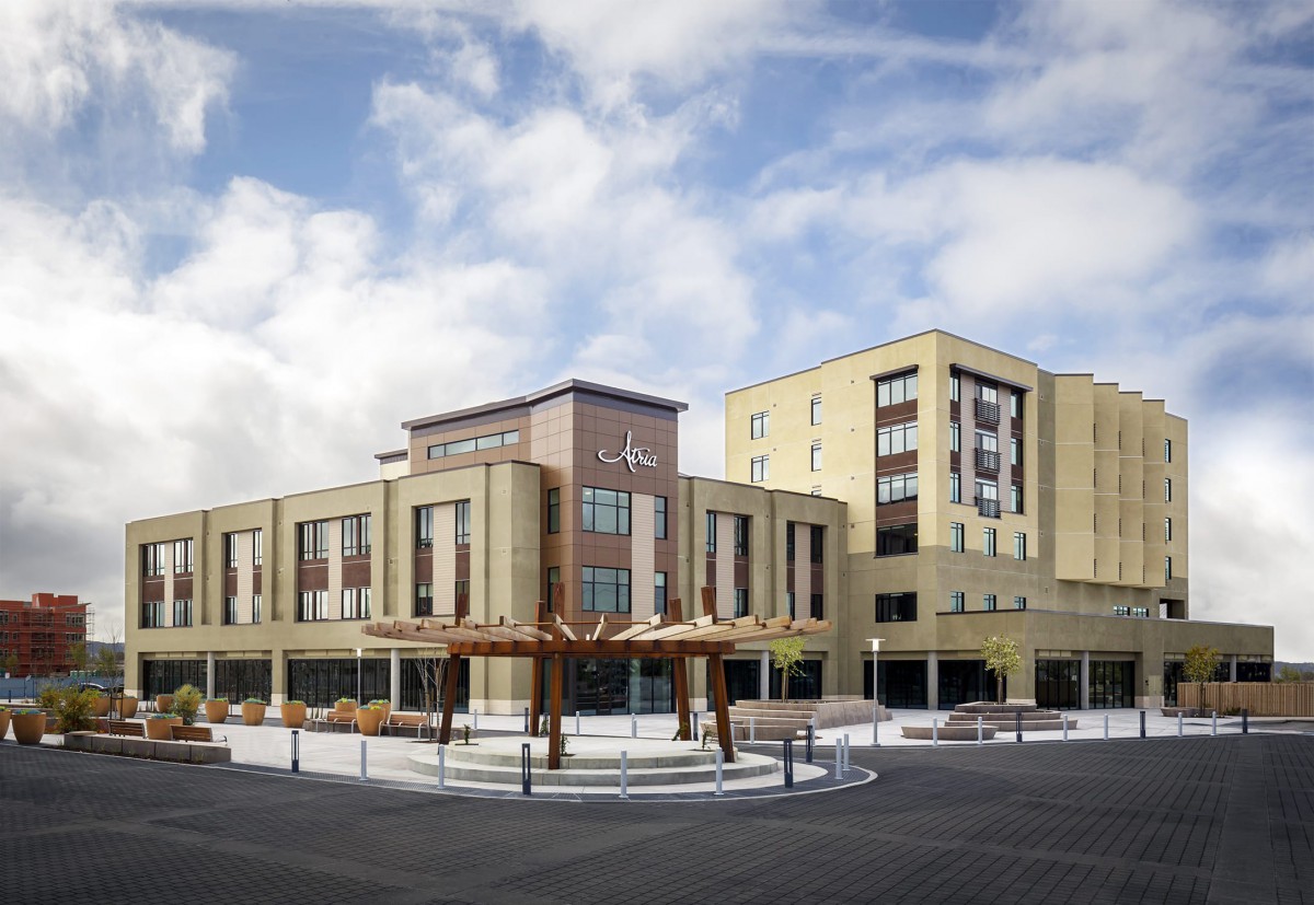 A modern commercial building with a blend of architectural styles under a partly cloudy sky.