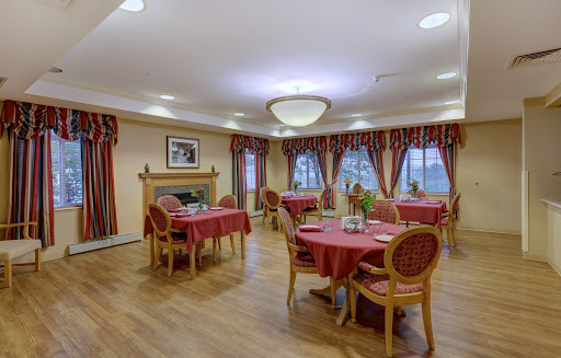A cozy dining area with red tablecloths and elegant furnishings, perfect for gatherings.