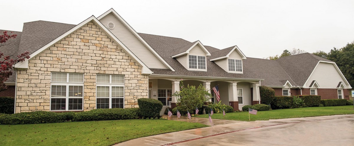 A suburban house with a stone and siding exterior.