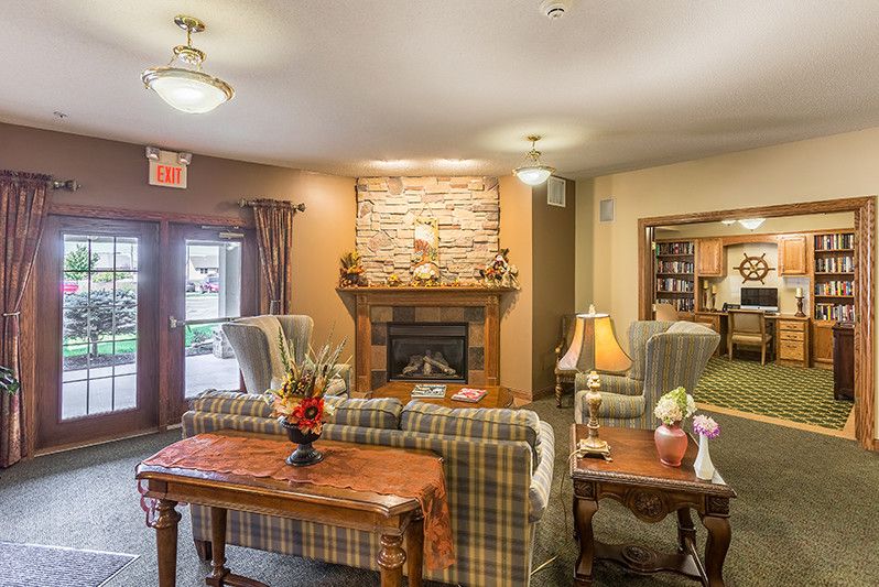 A cozy living room with a fireplace and comfortable seating.