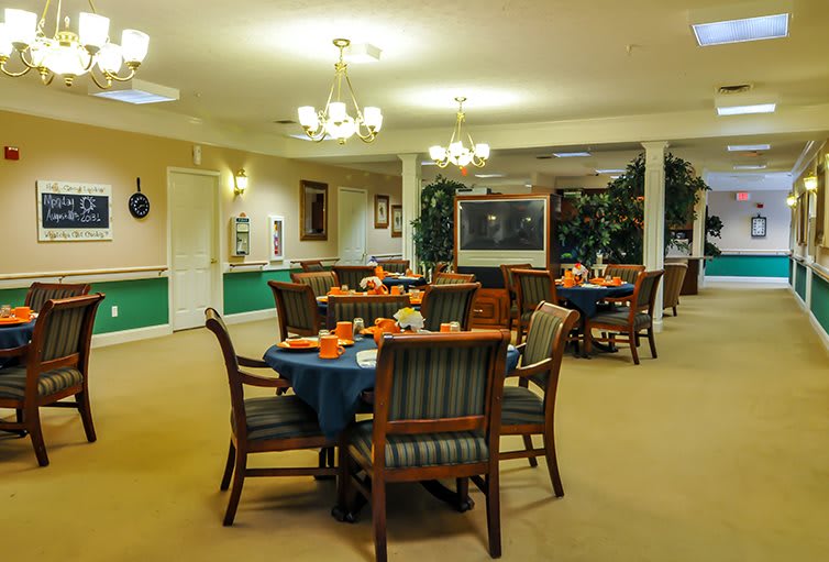 A well-lit dining area with neatly arranged tables and chairs.