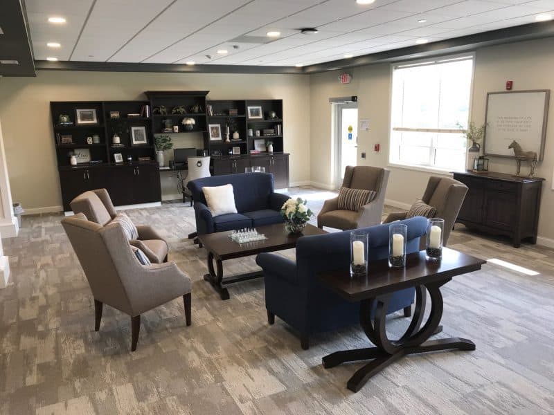 A modern lobby seating area with sofas, chairs, and a coffee table.