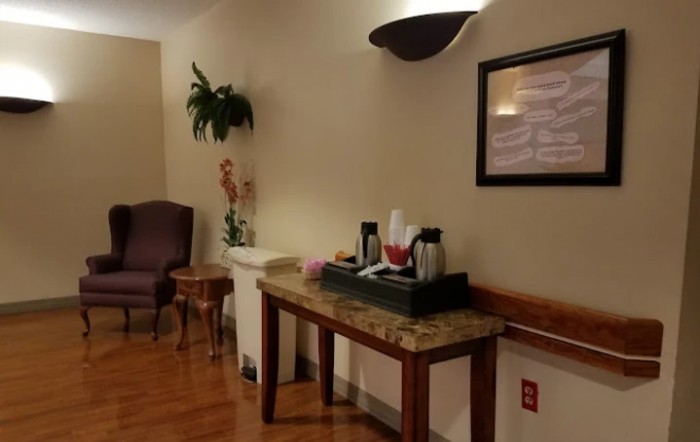 A cozy waiting area with a coffee station and seating.