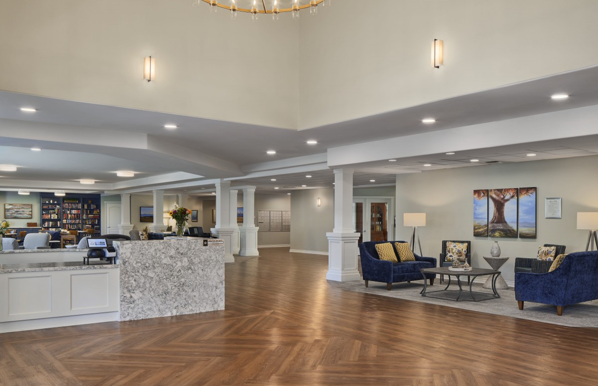 A spacious and modern lobby with a reception desk and comfortable seating area.