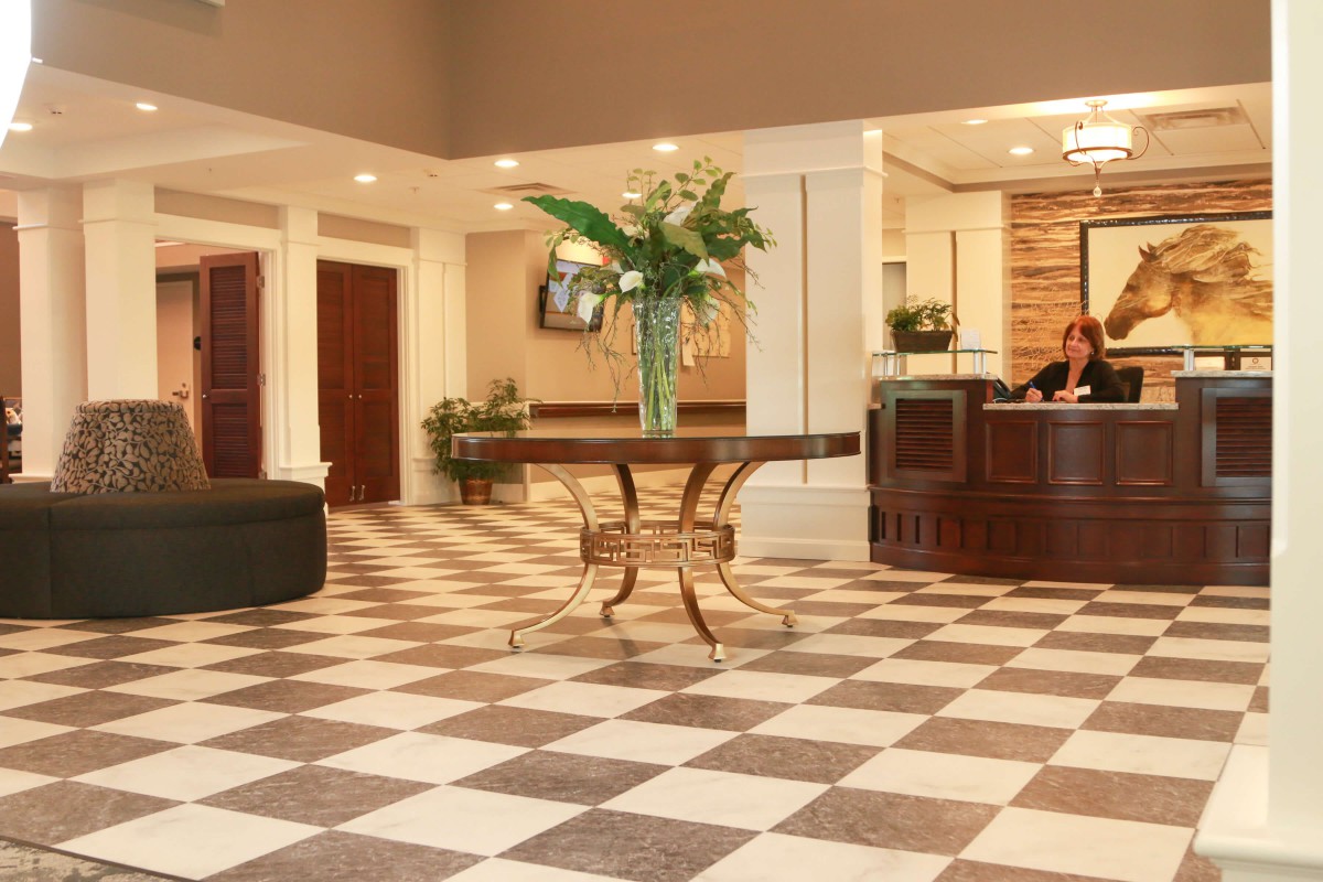 A welcoming hotel lobby with a checkered floor and elegant decor.