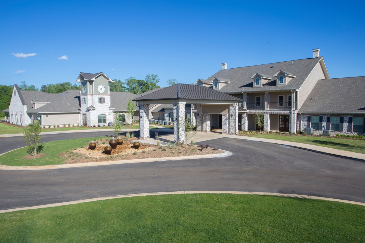 A luxurious residential estate with a grand entrance and well-maintained landscaping.