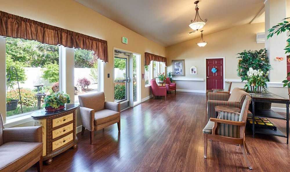 A bright and welcoming lobby area with comfortable seating and large windows.