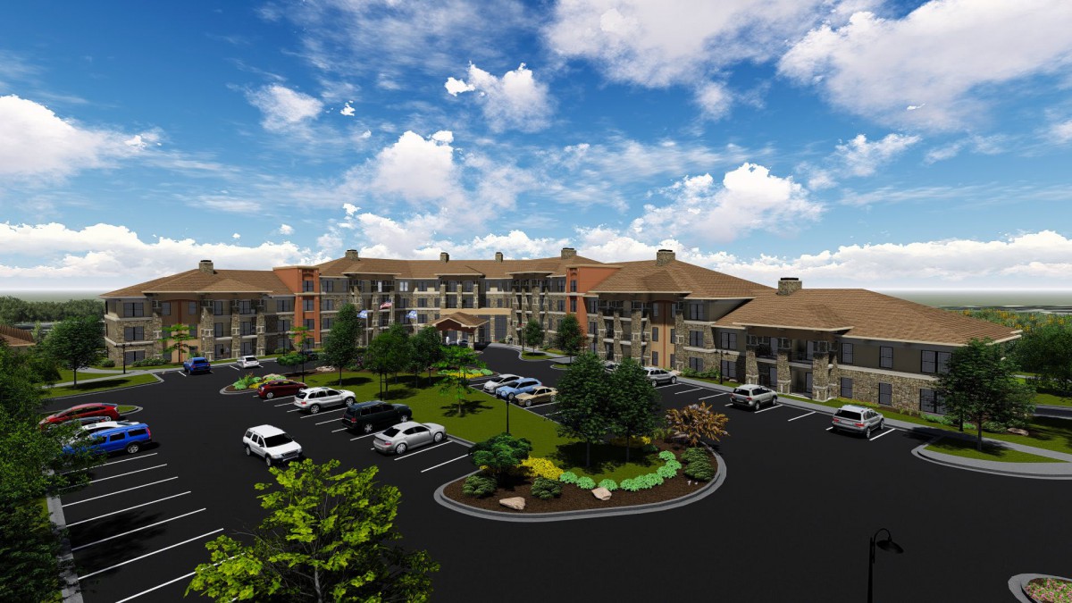 A large building with a parking lot and landscaped greenery under a cloudy sky.