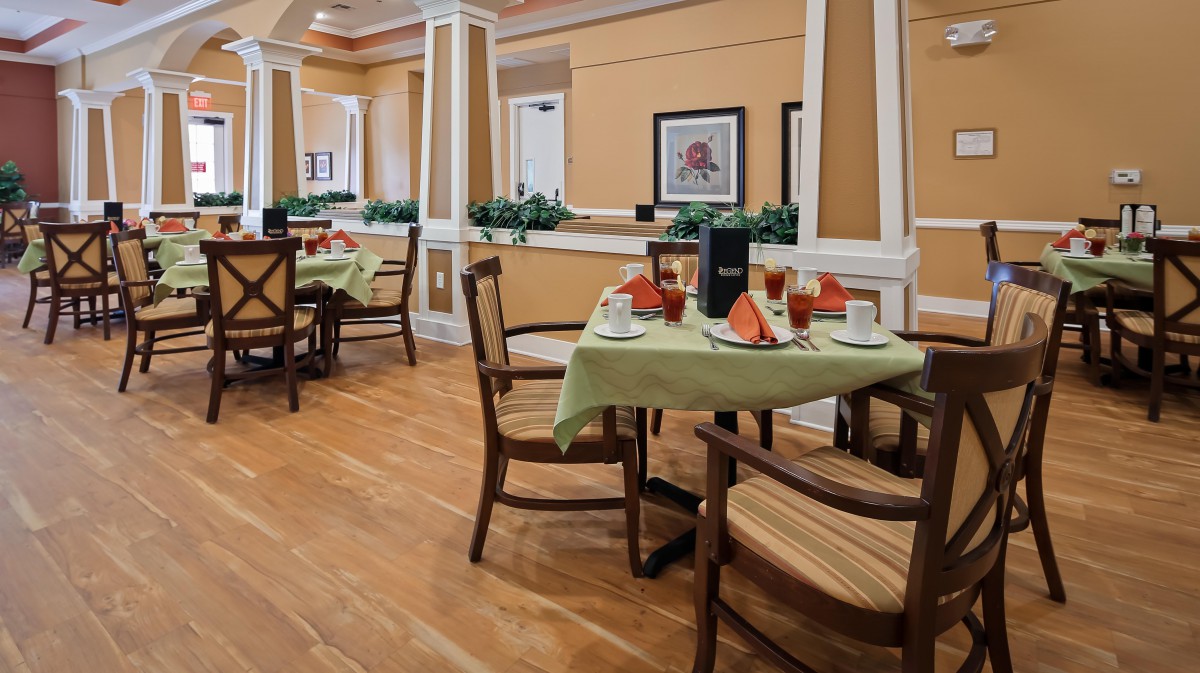 A cozy dining area with elegantly set tables and comfortable seating.