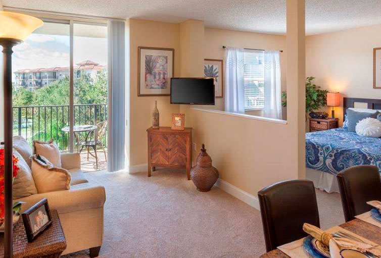 A cozy apartment living room with a view of the balcony.