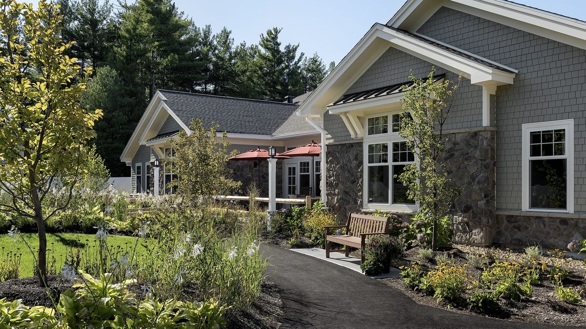 A charming residential building with well-maintained landscaping and a garden path.