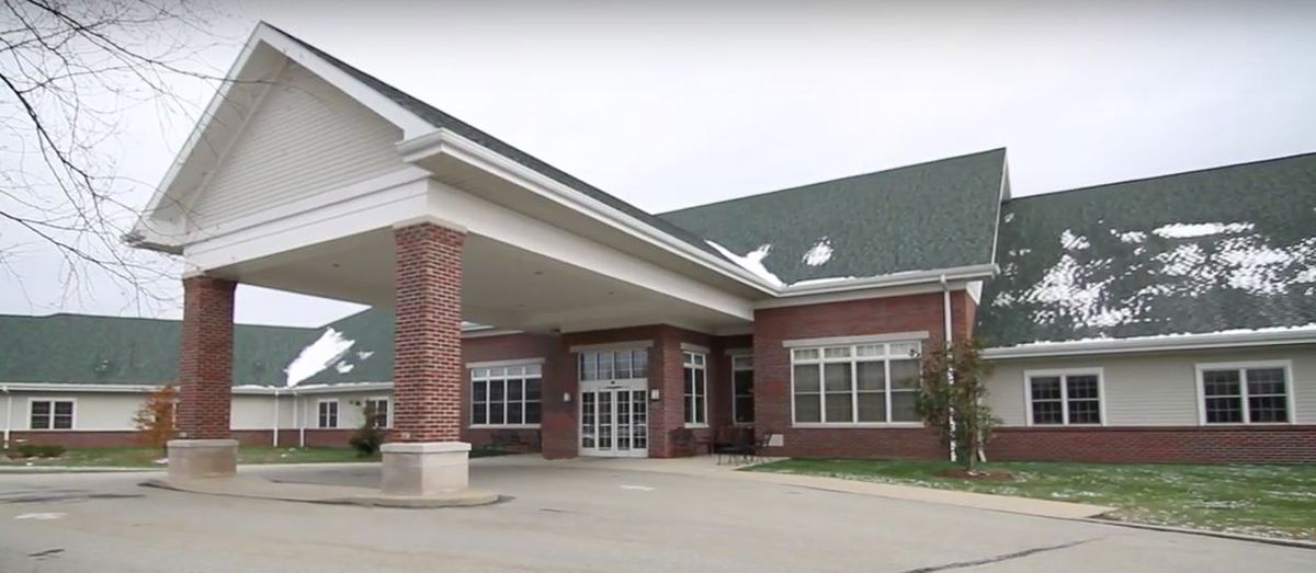 A building with a prominent entrance and brick exterior.