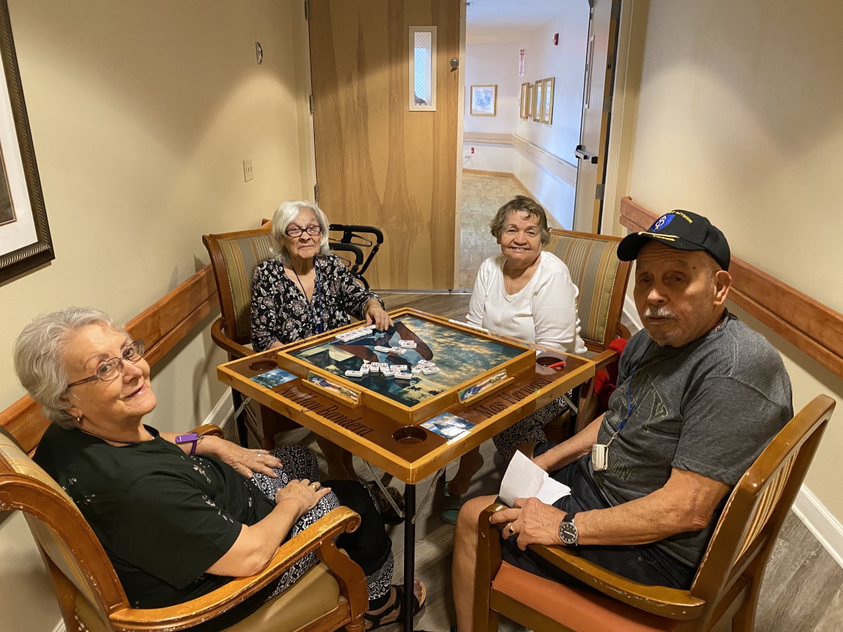 A group of seniors enjoying a puzzle together at a table.