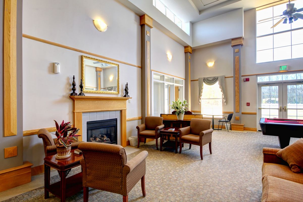 A spacious and elegantly decorated lobby with a fireplace and comfortable seating.