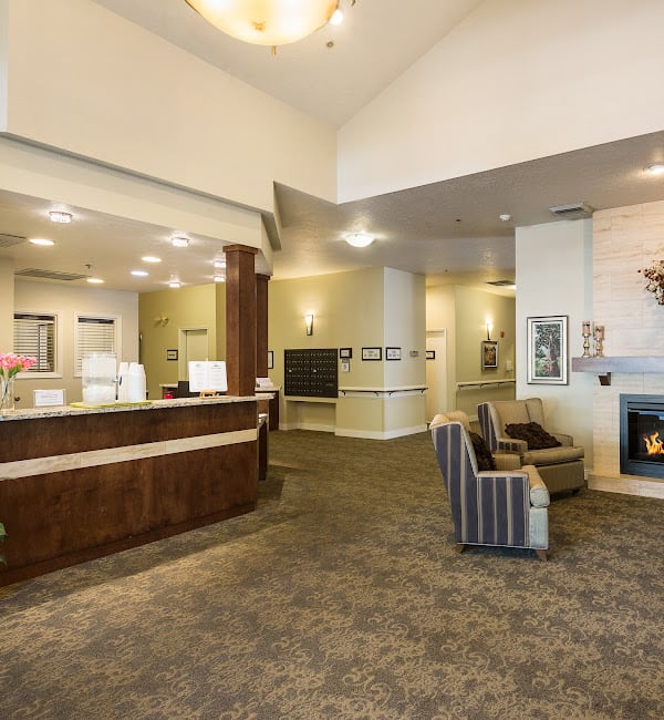A spacious and well-lit lobby with a reception desk and comfortable seating area.