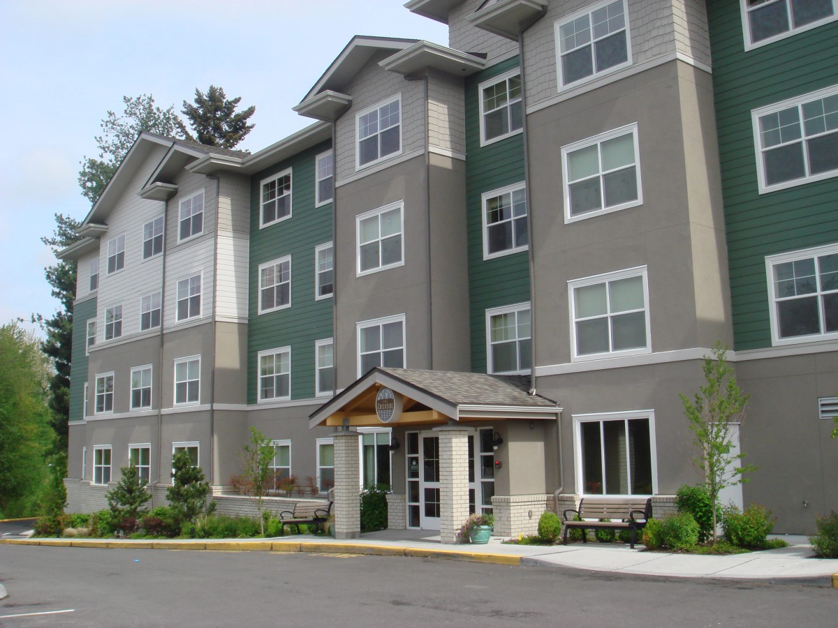 A modern apartment building with multiple floors and a welcoming entrance.