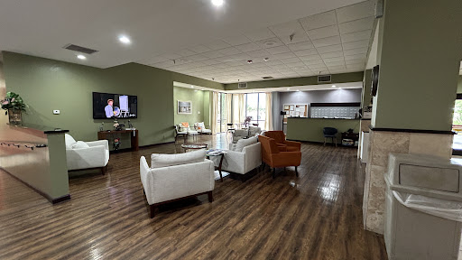 A modern lounge area featuring comfortable seating and a welcoming atmosphere, perfect for relaxation or waiting.