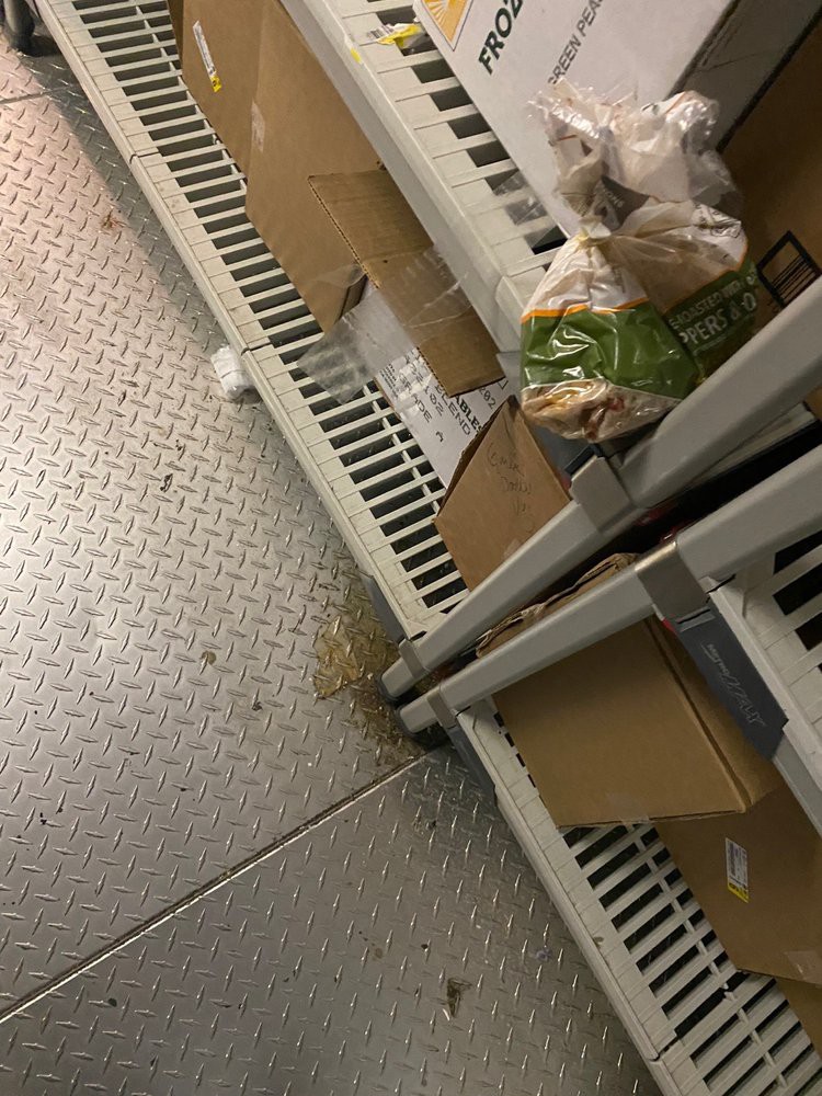 Boxes and items stored on metal shelves in a warehouse.
