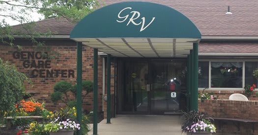 Entrance with a green awning labeled 'GRV' leading to glass doors.