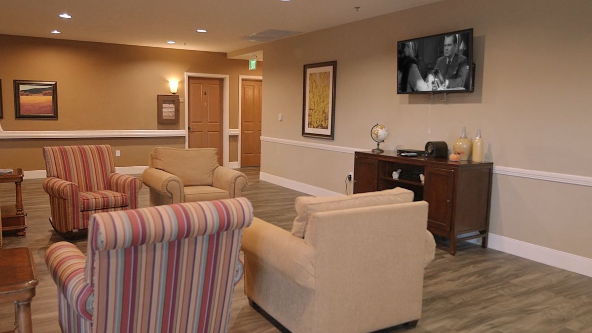 A cozy lobby area with comfortable seating and a television.