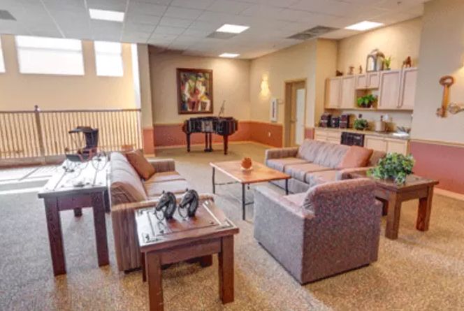 A spacious and well-decorated living room featuring comfortable sofas and a coffee table.