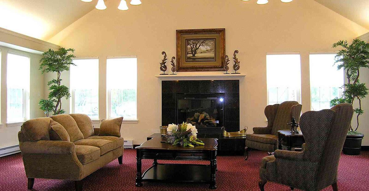 A cozy living room with a fireplace, sofas, and a coffee table.