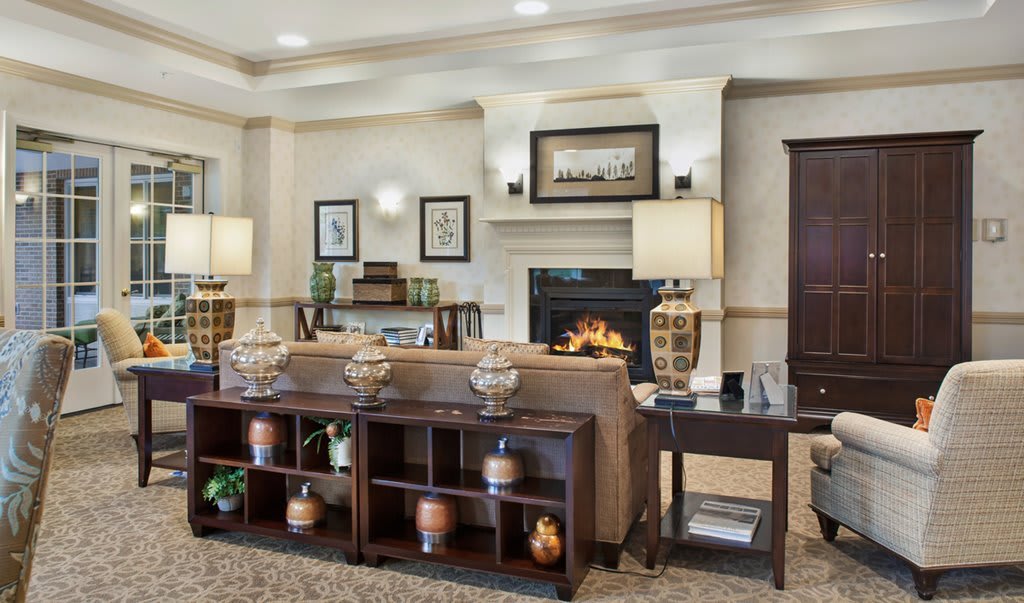 A cozy living room with a central fireplace and elegant decor.