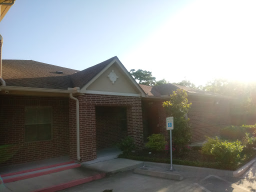 A sunny view of a brick residential building.
