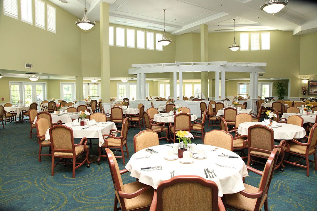 An elegant dining room with neatly arranged tables and chairs, ready for guests.