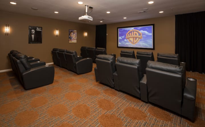 A cozy home theater setup with recliner chairs and a large screen.