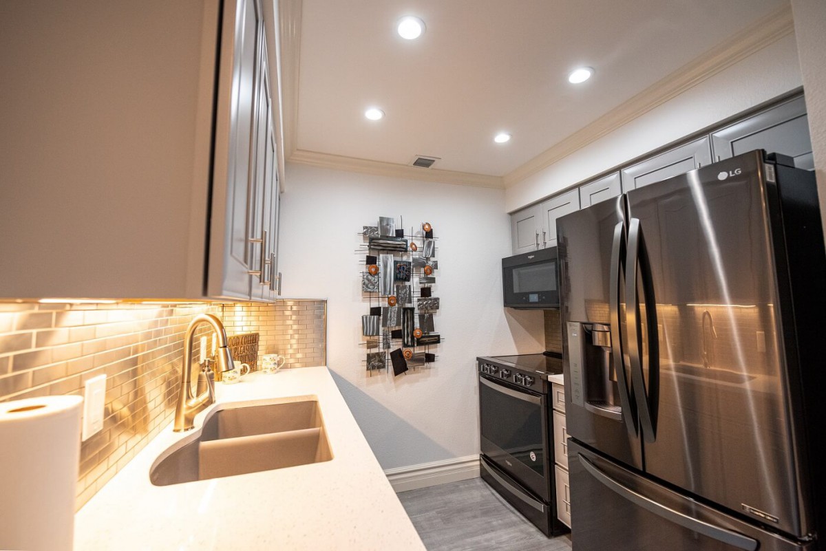 A modern kitchen with stainless steel appliances and contemporary design elements.